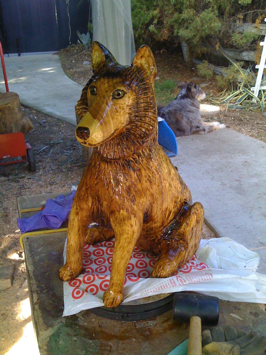 Wood carving of a dog, sculppture of a dog, art