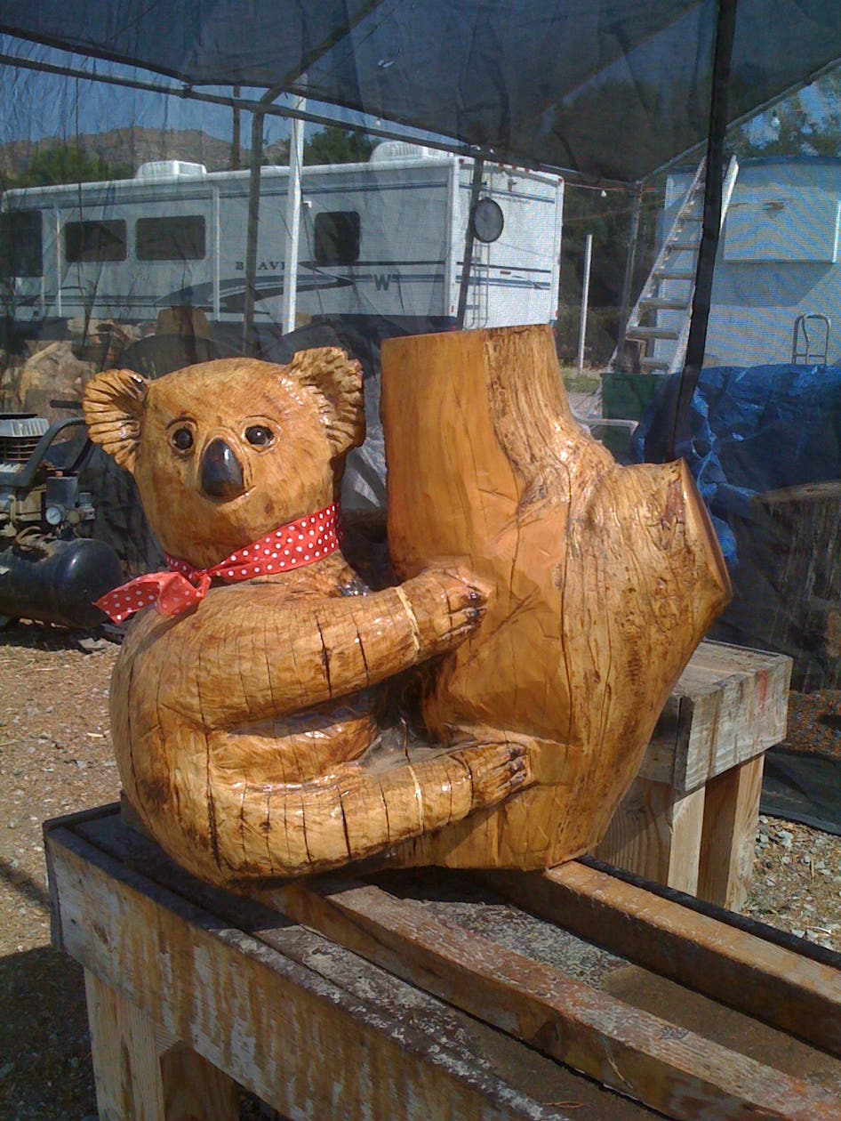 wood carving of a koala bear, sculpture of a koala bear, chainsaw woodcarving of a koala bear, art, sculpture